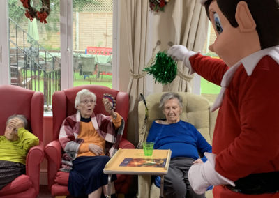 Residents enjoying a dance party with a giant elf at Lulworth House