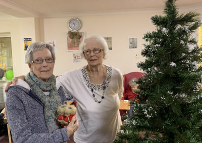 Lulworth House Residential Care Home residents standing by a Christmas tree