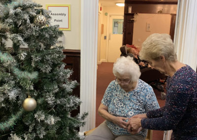 Lulworth House Residential Care Home residents deciding on decorations for their Christmas tree