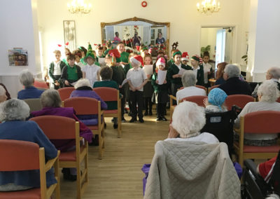 The Minterne School Choir singing for residents at Woodstock Residential Care Home