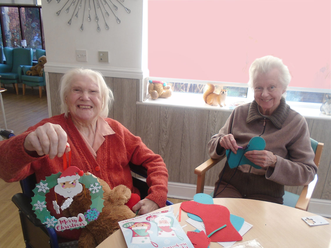 Ladies at The Old Downs displaying their festive handmade Christmas decorations