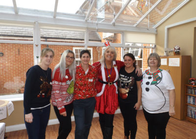 The staff team at Princess Christian in Christmas jumpers and outfits