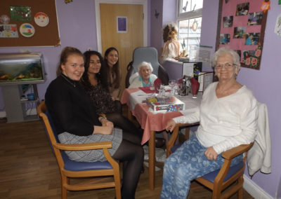 Princess Christian volunteer Pam playing board games with residents