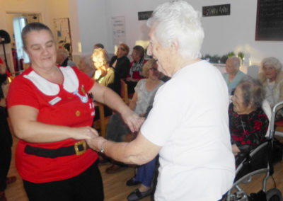 Woodstock Residential Care Home resident dancing with a staff member in a Santa costume
