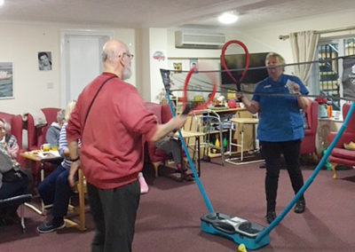 Lulworth House resident and staff member playing indoor badminton