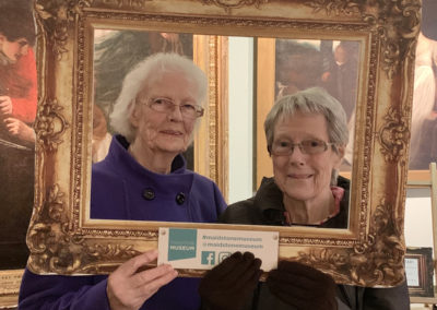 Two Lulworth ladies posing for a photo with a large gold frame
