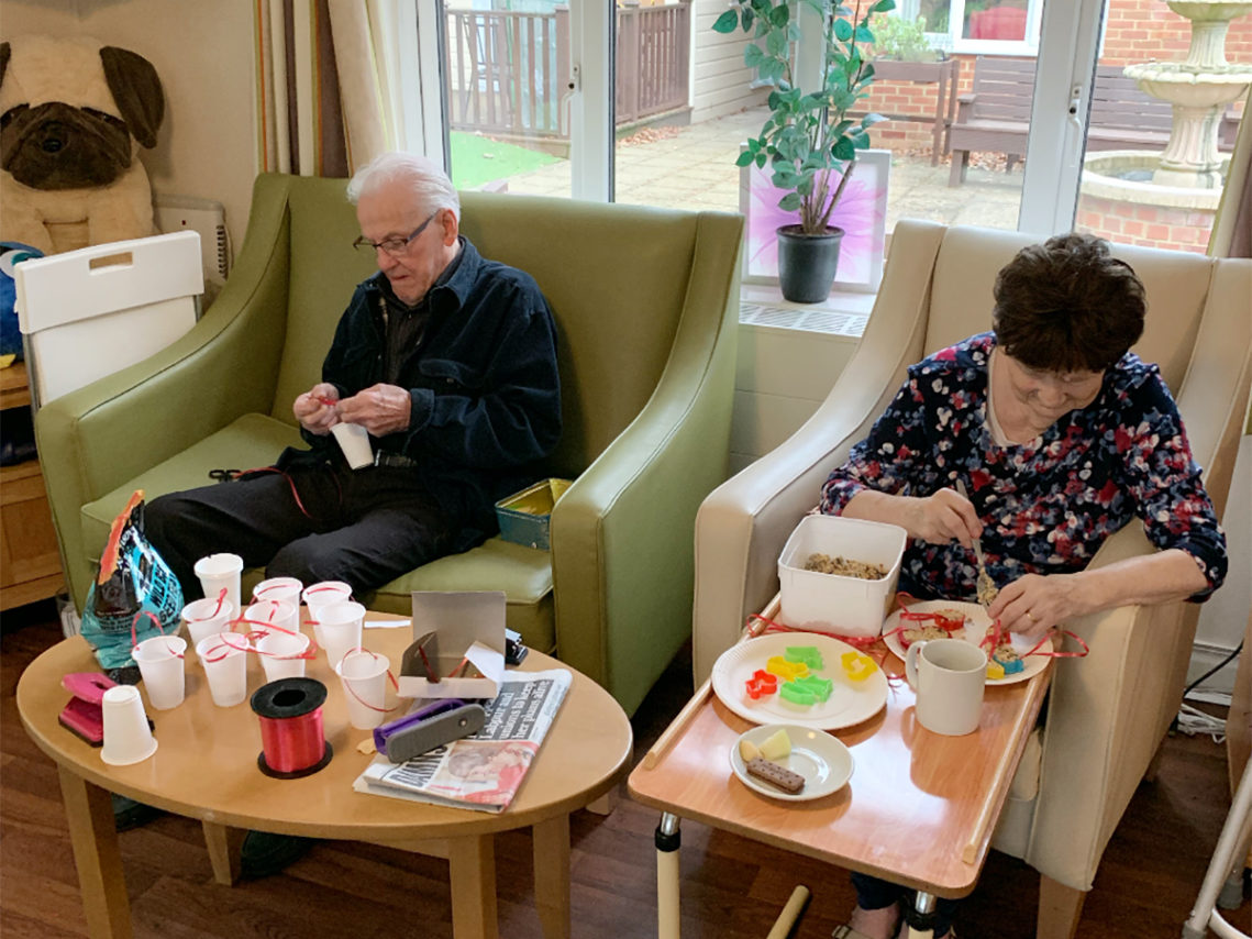 Lulworth House Residential Care Home residents making seed bird feeders