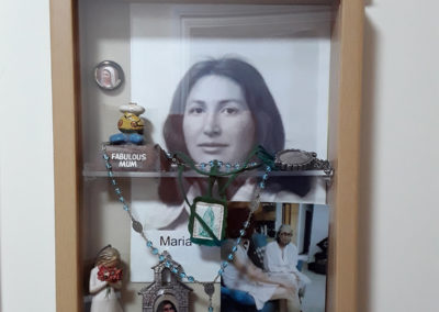 Resident Maria's memory box containing photos and rosary beads