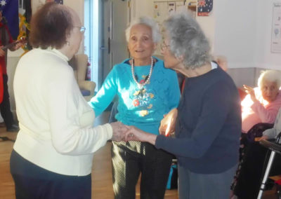 A group of Woodstock Residential Care Home lady residents dancing together to music by Rob T