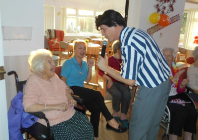 Resident Lily singing along to the entertainer at Woodstock Residential Care Home