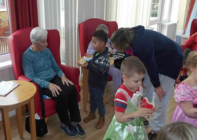 Nursery children socialising with Woodstock Residential Care Home residents