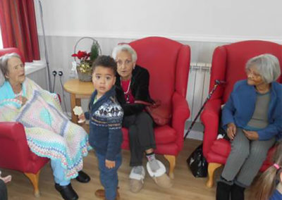 Woodstock Residential Care Home residents socialising with a little boy from Rodmersham Nursery