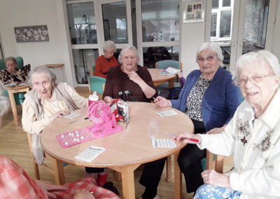 A group of ladies at The Old Downs playing bingo with new resident Gwen