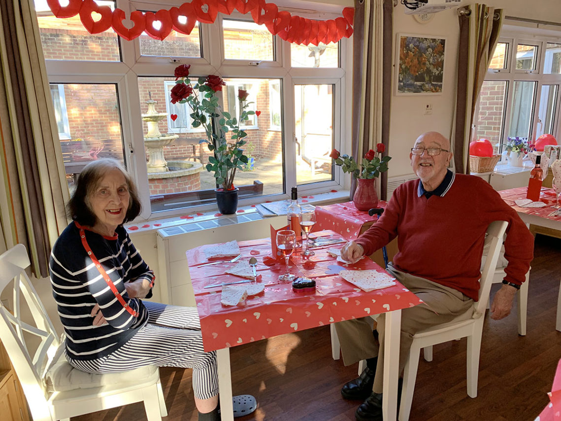 Couple sitting at a lunch table ready for a special Valentines meal