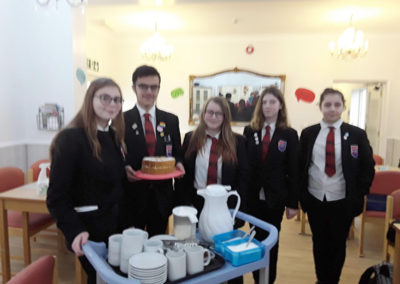 Oasis College students who volunteered to help with the Dignity Day afternoon tea party