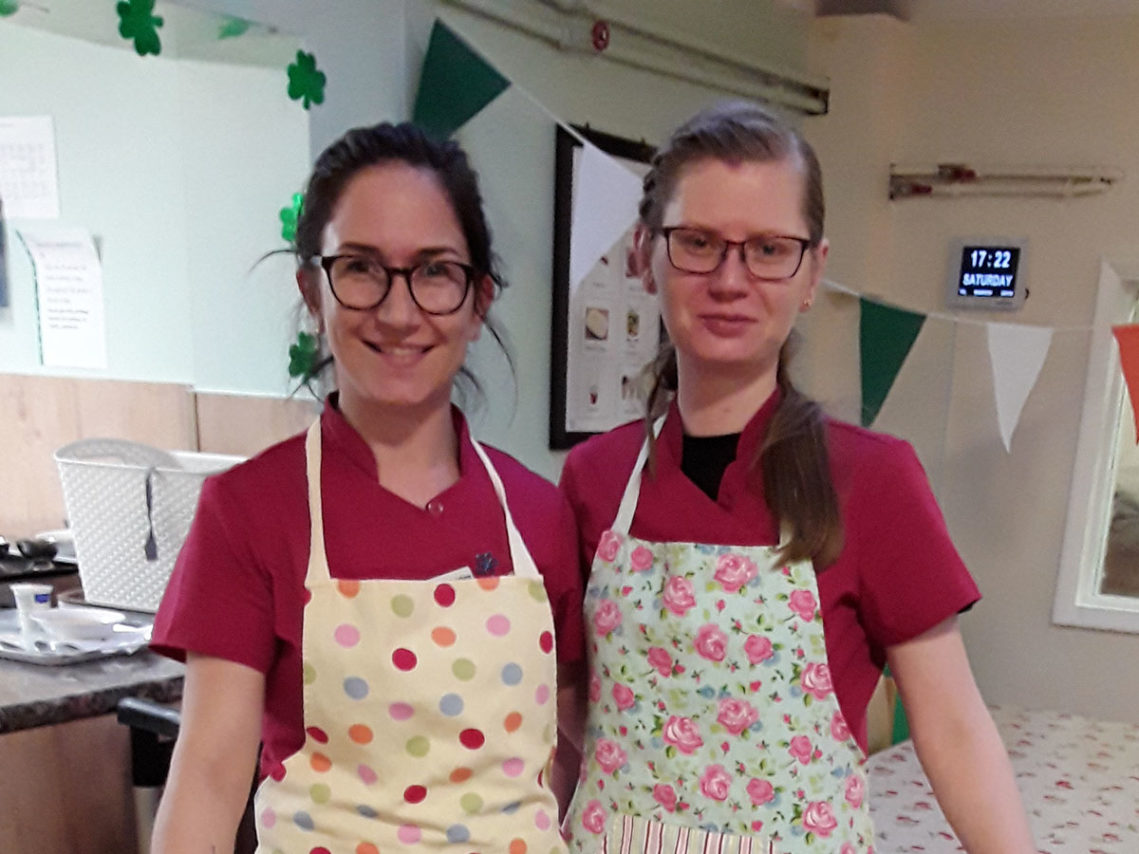 Two staff at Lulworth House Residential Care Home in aprons