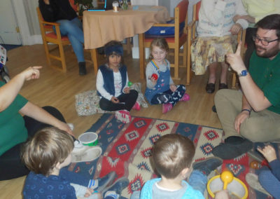 Children from Little Squirrels Nursery singing nursery rhymes together at Woodstock Residential Care Home