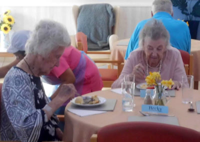 Residents eating pancakes for lunch at Woodstock Residential Care Home