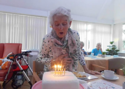 Woodstock resident Margaret blowing out her birthday cake candles