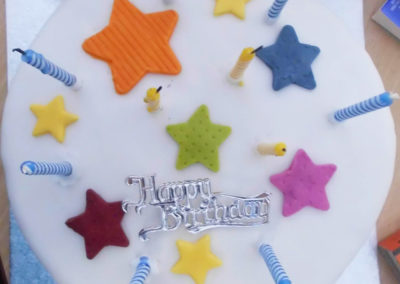 Resident birthday cake with star icing and candles