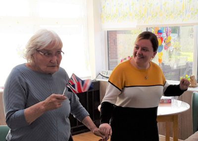 Resident and staff member dancing together at The Old Downs Residential Care Home