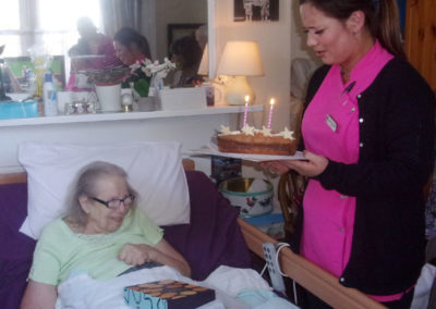Loose Valley Care Home resident receiving a birthday cake with candles