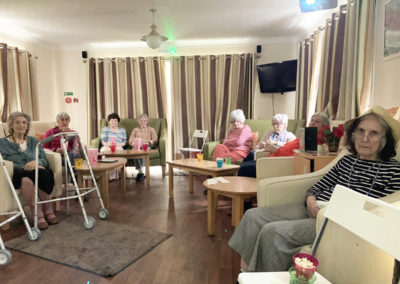 Lady residents in their lounge, seated for Cinema Club