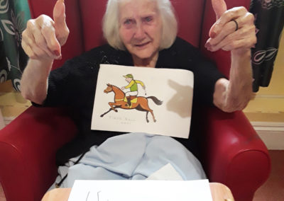Lady resident with her thumbs up as she's won the grand National 1st prize