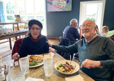 Resident and her husband sitting in a pub enjoying lunch together