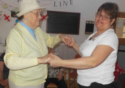 Staff member and resident dancing together