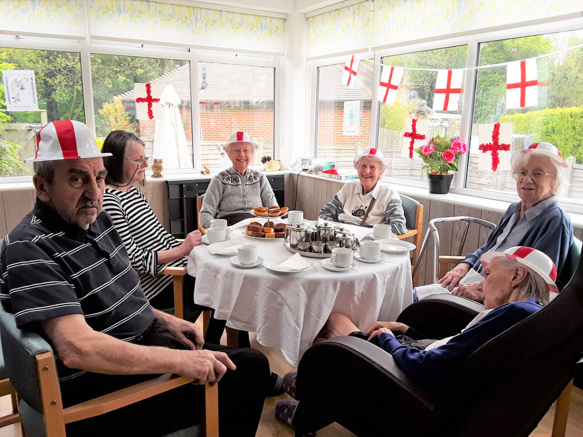 Residents around a table enjoying a St George's Day afternoon tea