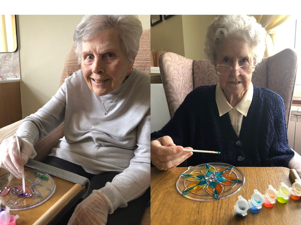 Ladies at Silverpoint Court painting sun catchers