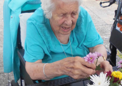 Woodstock lady resident arranging flowers at a table in the garden