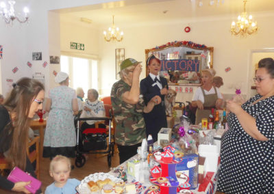 The Woodstock lounge decorated for VE Day, with staff, residents, family and friends
