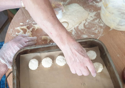 Resident laying out scones for the oven