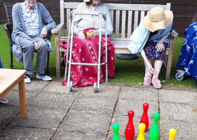 Residents playing skittles in the garden at Lulworth House
