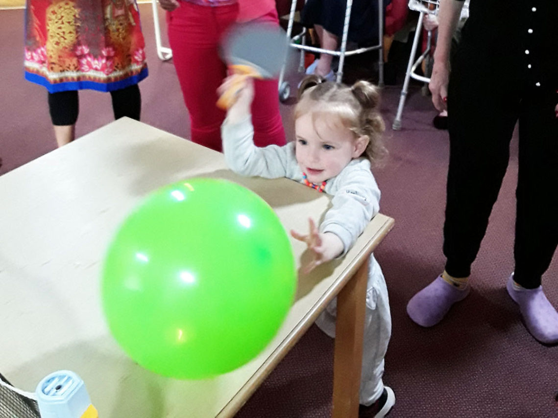 Nursery children playing with a balloon at Lulworth House Residential Care Home