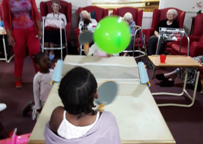 Nursery children playing balloon table tennis at Lulworth House Residential Care Home
