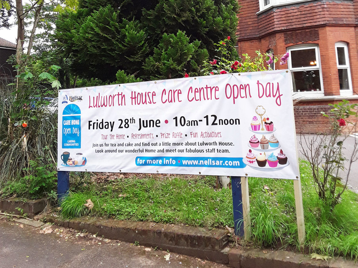 Front of Lulworth House with a banner promoting their Open Day