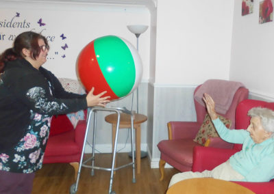 Volunteer playing catch with a resident at Woodstock Residential Care Home