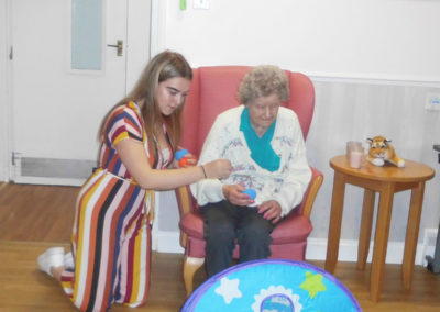 Volunteer playing target throw with beanbags with a resident at Woodstock Residential Care Home
