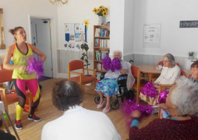 Lady residents enjoying a Zumba class at Woodstock Residential Care Home