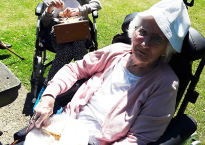 Residents eating a sandwich picnic at the park