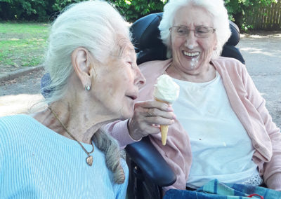 Two ladies with an ice-cream at the park