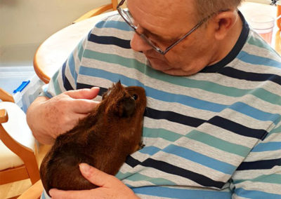 Male resident petting a Guinea pig