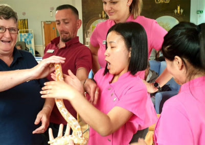 Staff at Lukestone holding a snake brought in by Wild Science experts