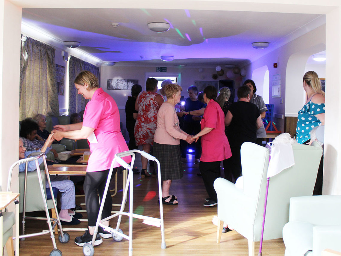 Staff and residents enjoying a disco at Bromley Park