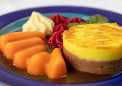 A puréed shepherd’s pie with carrots, mash and red and green cabbage