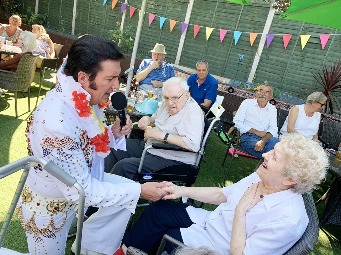 Elvis singer with a lady resident in the garden of Lulworth House
