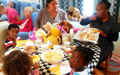 Nursery children and staff enjoying a tea party with teddies at Lukestone Care Home
